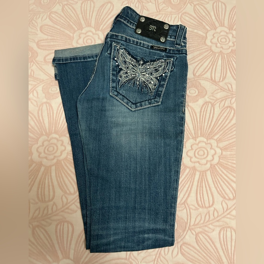 Authentic Miss Me bootcut jeans with silver embroidered and rhinestone pockets.